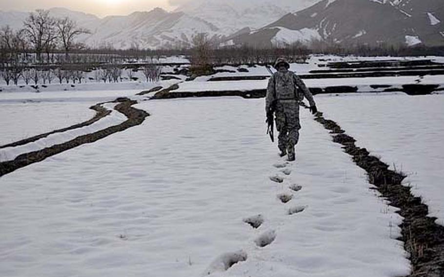 Capt. Kirby Jones slogs through the snow during a mission in the town of Khanjankhel in Wardak province. Jones, 31, of Bellingham, Wash., has almost completely abandoned using vehicles for his company&#39;s patrols, opting to walk, often across farm field, to minimize the threat of roadside bombs.