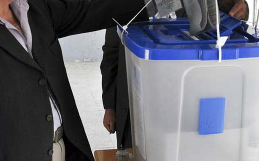 Aziz Mohamed casts his ballot at a polling place on Sadoon Street in eastern Baghdad. Mohamed, a Kurd, said he chose a cross-sectarian alliance over the main Kurdish bloc.