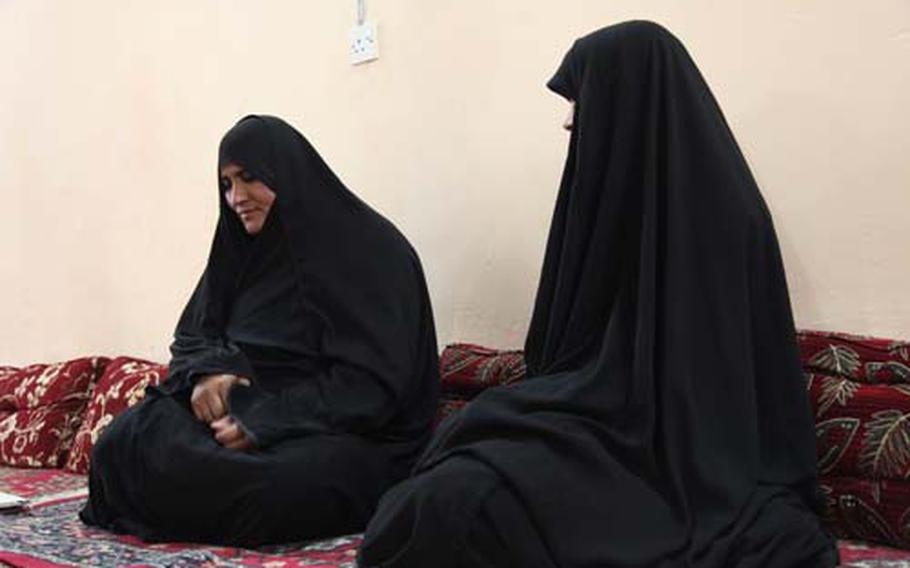 Fawzia Abdalaabi Hassan, left, whose husband was killed in a tribal dispute 12 years ago, finds herself in a similar situation as many Iraqi widows. With no government help and no family to support her, she says she is forced to rely on handouts and has already married off her two teenage daughters and taken her 12-year-old son out of school.
