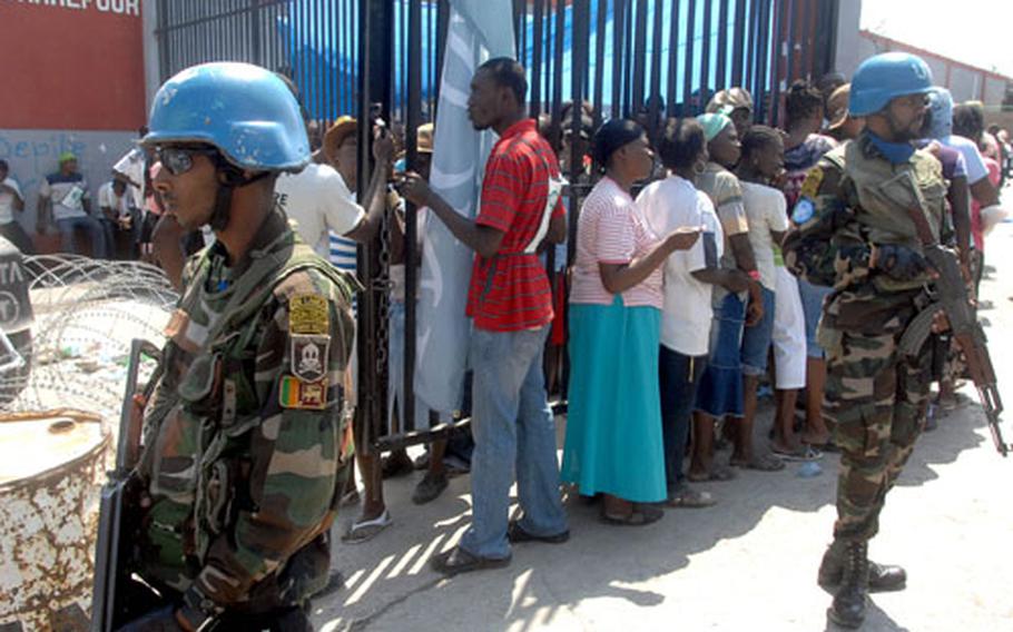 Sri Lankan peacekeepers provided security along with Haitian police at this food distribution point in Carrefour on Wednesday.