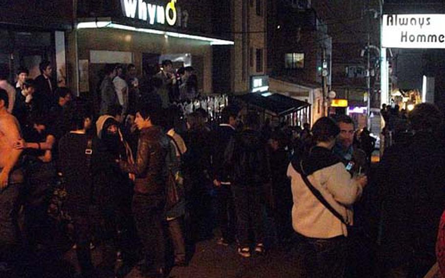 Customers mingle outside the bars of Homo Hill, a popular gay district near U.S. Army Garrison-Yongsan in Itaewon frequented by gay U.S. troops. The district is also popular with straight customers.