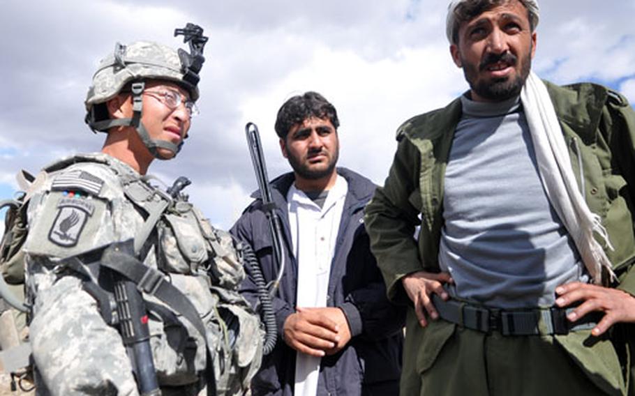 First Lt. Scott Yang talks to a member of the Afghan Provincial Protection Force in Wardak province.