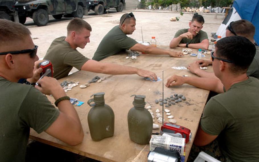 Marines in Carrefour kill time by playing cards, but they&#39;ve also begun to prepare for a deployment to Afghanistan in the spring.