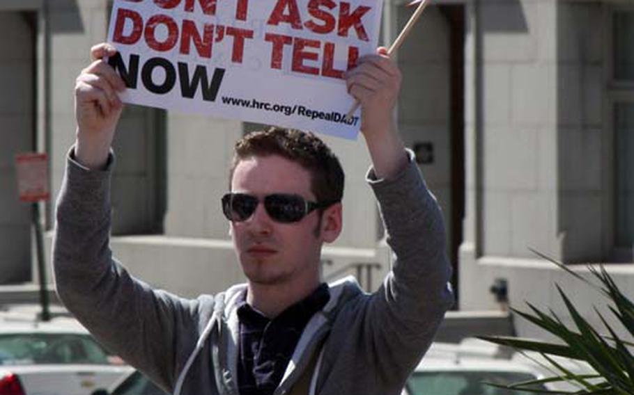 A protestor cheers on calls for a repeal of the military’s “don’t ask, don’t tell” law .