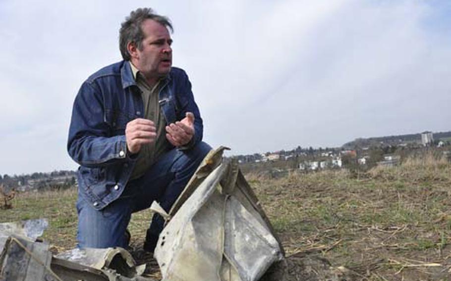Horst Weber, a local historian in Bitburg, Germany, who has been researching World War II history here since 1993, shows off some of the scraps of the P-47 Thunderbolt found in the farm hills outside of town. The plane was found in a plot of land owned by the Volksbank, which is slated for development.