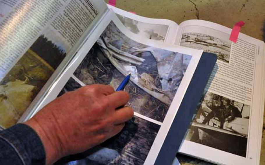 Weber points to a photograph of a World War II era P-47 Thunderbolt. The plane&#39;s scraps are now in a heap in the bank&#39;s cellar, placed there for safekeeping after this panel was stolen from the excavation site. The panel is marked with a reverse swastika--an emblem commemorating one of Dahlberg&#39;s kills.