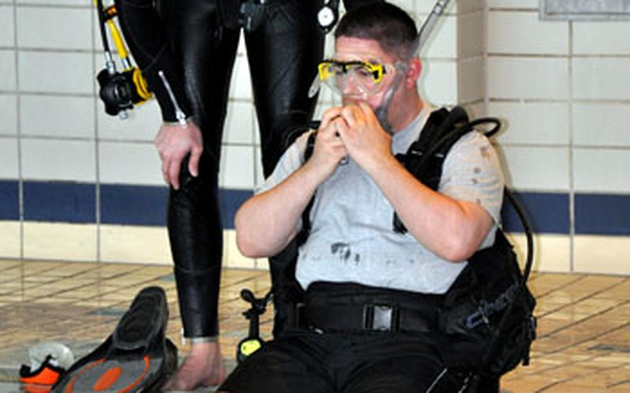 Sgt. Charlie Melendez prepares for his first dive during a scuba class on Sunday.