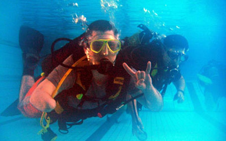 Spc. Jake Altman, who lost part of his right arm while deployed to Iraq, participates in a scuba diving class for wounded warriors.