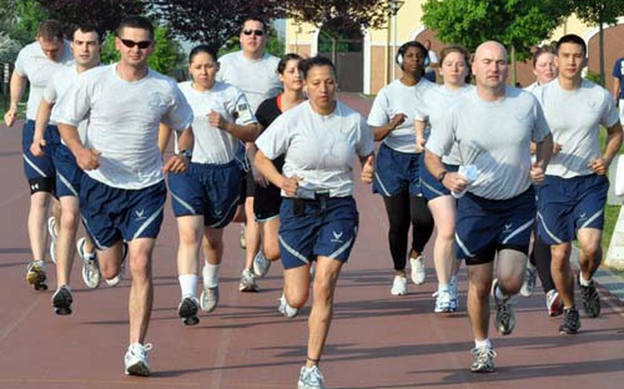 Airmen with the 31st Operations Support Squadron at Aviano Air Base in Italy begin their 1.5-mile run Friday morning during physical fitness testing under the current standards. New standards go into effect July 1.