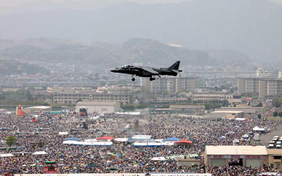 An AV-8B Harrier demonstrates its vertical/short takeoff and landing maneuvers in front of thousands of spectators during the annual Friendship Day air show at Marine Corps Air Station Iwakuni.