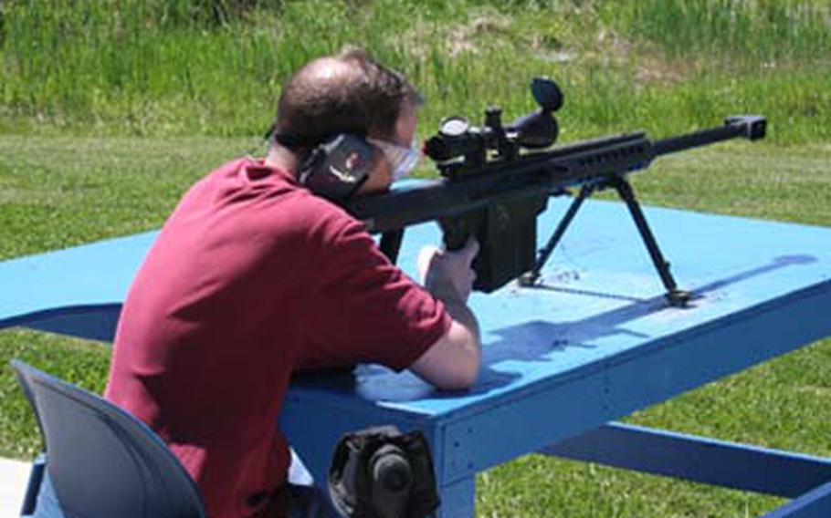 Stars and Stripes copy editor Thomas Ruyle fires the M107 .50-caliber sniper rifle, which has such a strong recoil that it will rattle your teeth, he said.