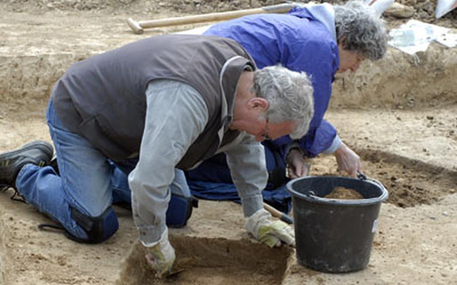 The husband-and-wife team of Eric Robinson and Sue Zarutskie dig in the dirt searching for Roman settlement artifacts on May 5 at the construction site of a future $133 million Army Corps of Engineers housing complex adjacent to Wiesbaden Army Airfield.