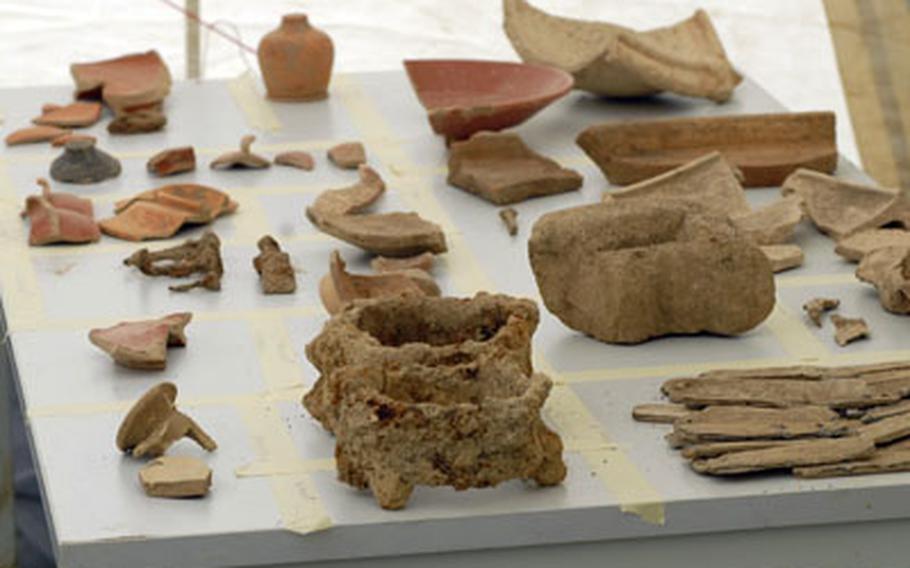 Artifacts from around the first century A.D. sit on display near the excavation site of what German archaeologists say was a Roman farming settlement.