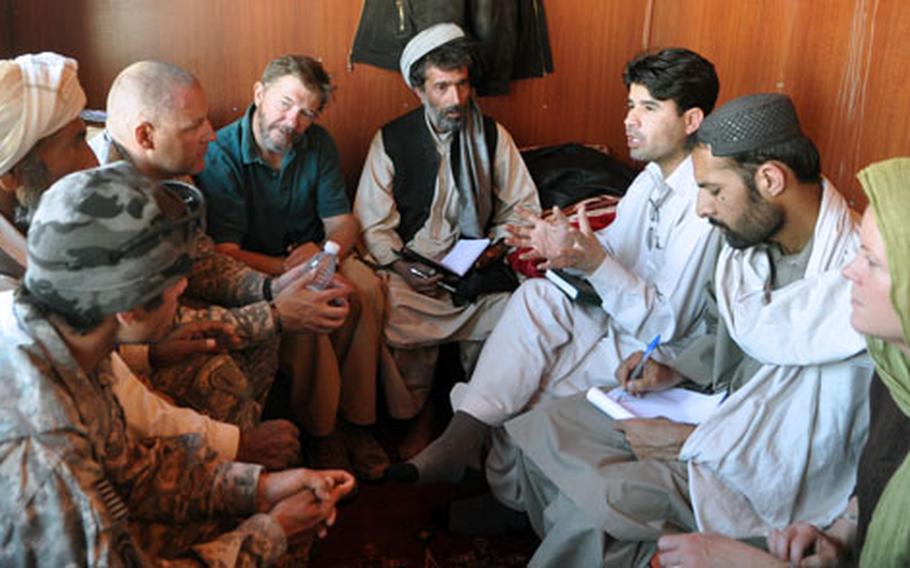 Ghulam Faruq Hamayoon, sub-governor of Logar province’s Kharwar district (sitting under the jacket), meets with soldiers and reconstruction officials in the cramped trailer that serves as his headquarters. Hamayoon, who was hired after the last sub-governor simply left and never returned, has no staff and says he feels abandoned by his government.