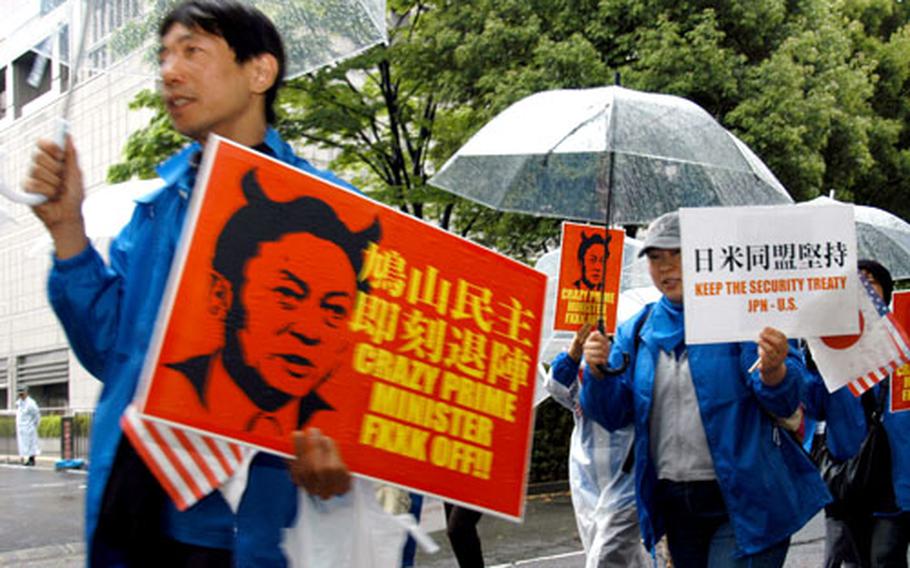 Protesters march in Tokyo on Tuesday, calling for a stronger U.S.-Japan alliance and Japanese government commitment to the 2006 agreement to close Marine Corps Air Station Futenma and move it to a new facility to be built at Camp Schwab.