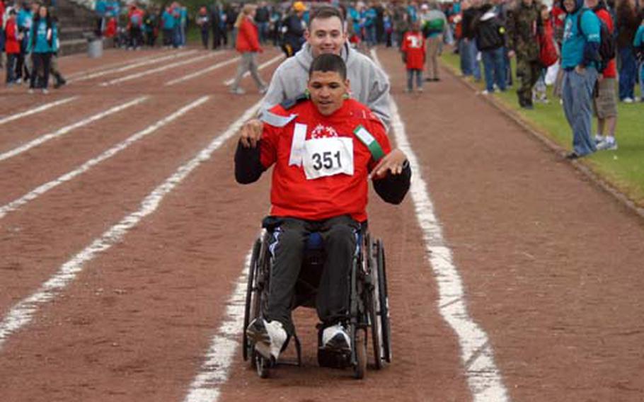 Special Olympian Etienne Glaster races down the track with buddy Andrew Medley.