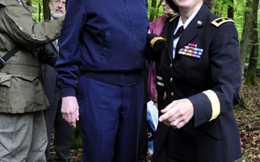 Retired Army Col. John E. Halver helps the Army&#39;s 100th Division commanding general, Brig. Gen. Patricia Heritsch, into a foxhole he fought in during a battle with Nazi forces on a hill near Lemberg, Germany on Victory in Europe Day on Saturday. Halver was a second lieutenant platoon commander when he fought there in 1945.