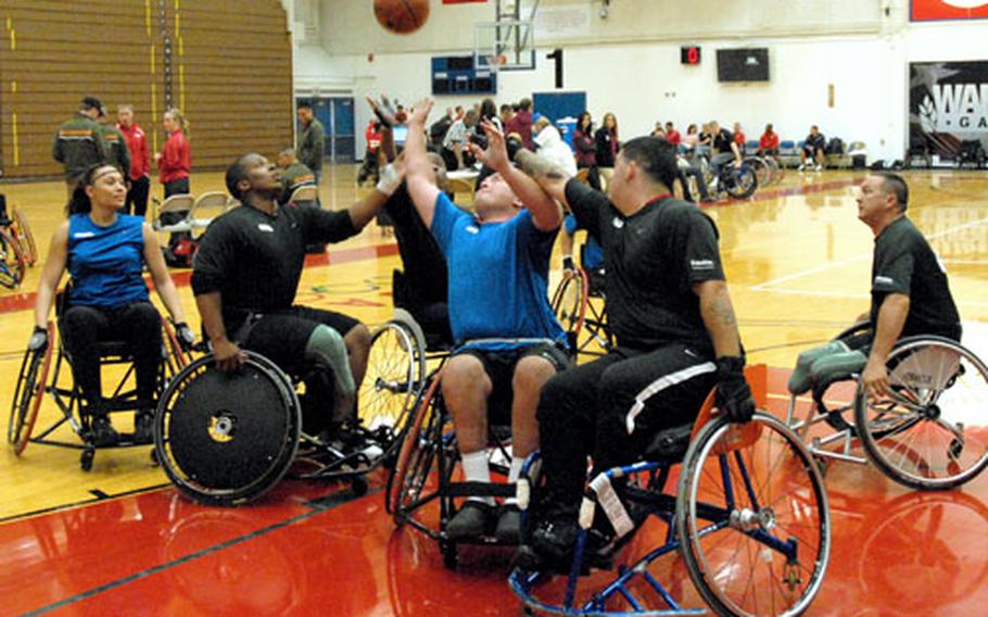 Air Force Staff Sgt. Richard Pollock, in blue in the center, reaches for a rebound from his teammates shot in a wheelchair basketball game Wednesday night against Army in the inaugural Warrior Games for wounded servicemembers. The Air Force ended up taking bronze in the competition. The Gold Medal game is Thursday night.