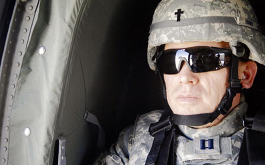 Chaplain (Capt.) Steve Fisher sits aboard a UH-60 Black Hawk en route to Baghdad in March. Fisher, the 732nd Expeditionary Group chaplain, visited more than 100 airmen in remote locations in Iraq.