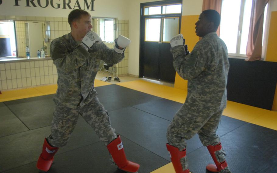 First Lt. Ian McCollum, left, and Sgt. Brintun Jones spar during Level II Combatives training at the 7th Army Noncommissioned Officer Academy last week.