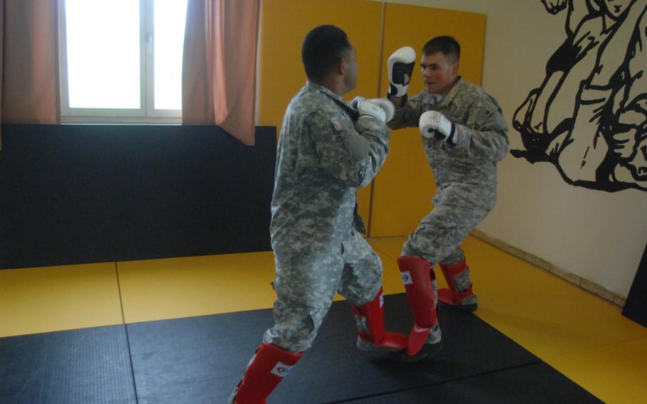 Sgt. Andrew Robles, left, and Pfc. Garrett Sorem spar during Level II Combatives training at the 7th Army Noncommissioned Officer Academy last week.