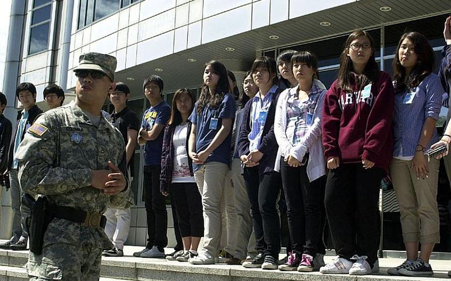 A United Nations Command security escort briefs a visiting group of teenagers Wednesday at the Joint Security Area of the Demilitarized Zone of Korea. Tours appeared to go on as usual despite rising tensions between North Korea and South Korea.