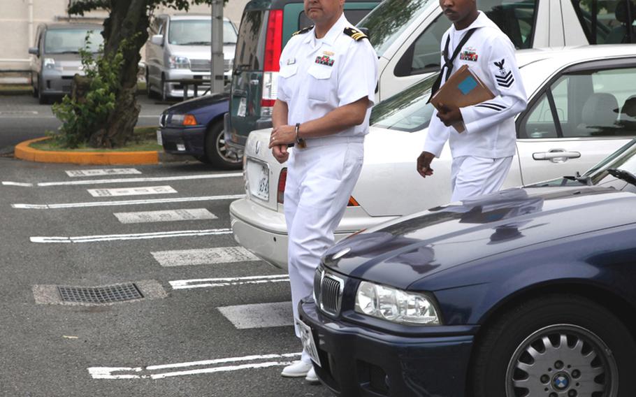 Navy Lt. Cmdr. Anthony Velasquez is escorted from the Yokosuka Naval Base court Wednesday after being found guilty on two counts of wrongful sexual contact and two counts of conduct unbecoming an officer.