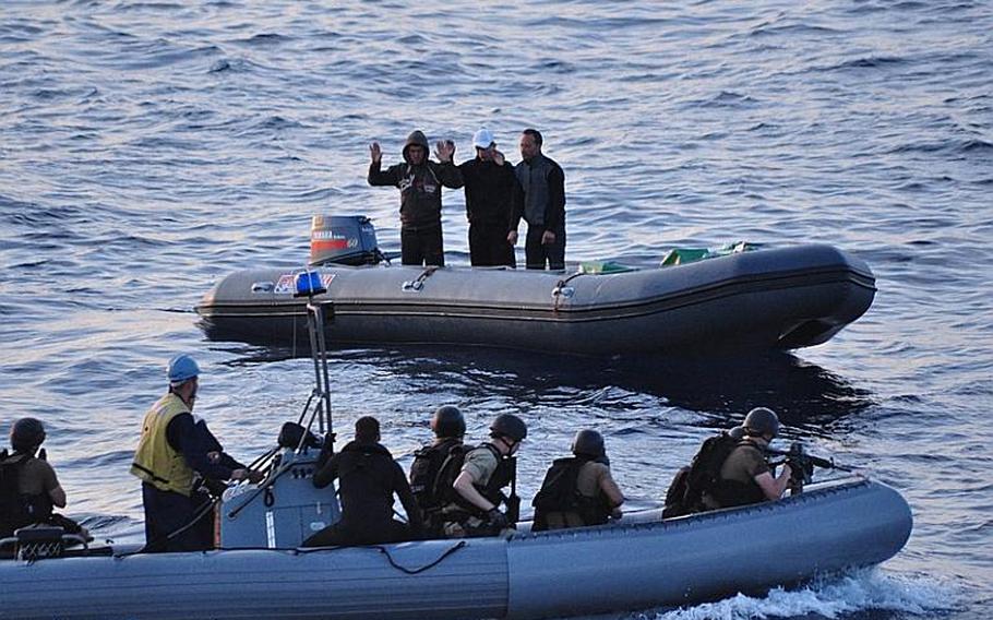 Suspected smugglers surrender to a search-and-seizure team from USS Elrod. A helicopter from the ship spotted the suspects dumping what turned out to be hundreds of pounds of narcotics overboard in the waters off the coast of Morocco Tuesday night. The suspects and drugs were turned over to Moroccan officials.