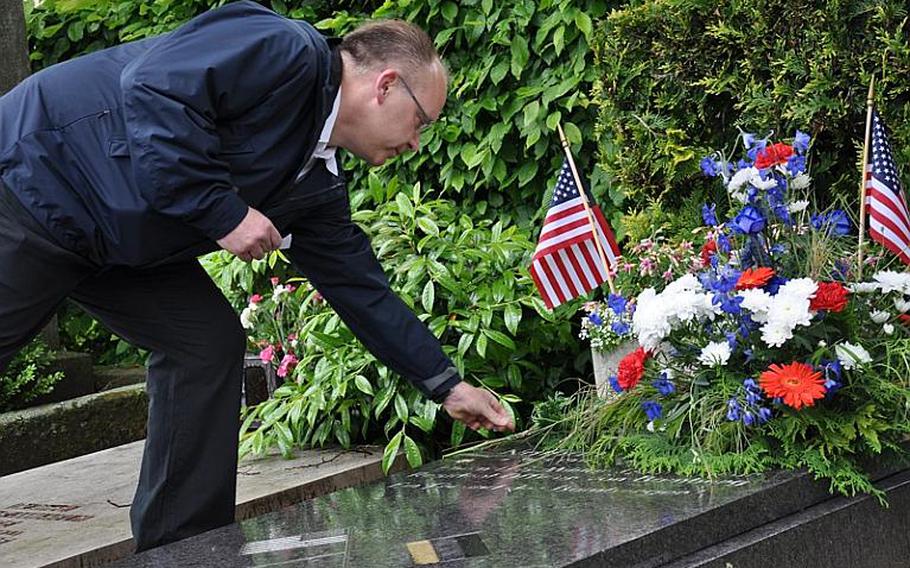Mark Lievense of the Bamberg, Germany, VFW on Sunday places flowers on the grave of Nathan R. Preston,  the city&#39;s first US military governor and resident officer following World War II.