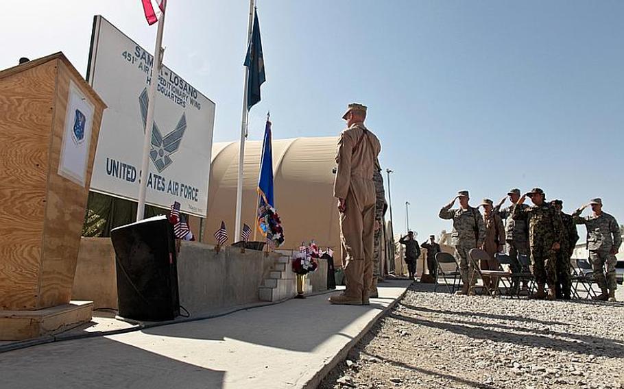 Brig. Gen. Guy Walsh, commander of the 451st Air Expeditionary Wing, and other U.S. and Afghan officers salute after a wreath is laid in honor of the nation's fallen during a Memorial Day ceremony Monday at Kandahar Airfield, Afghanistan.