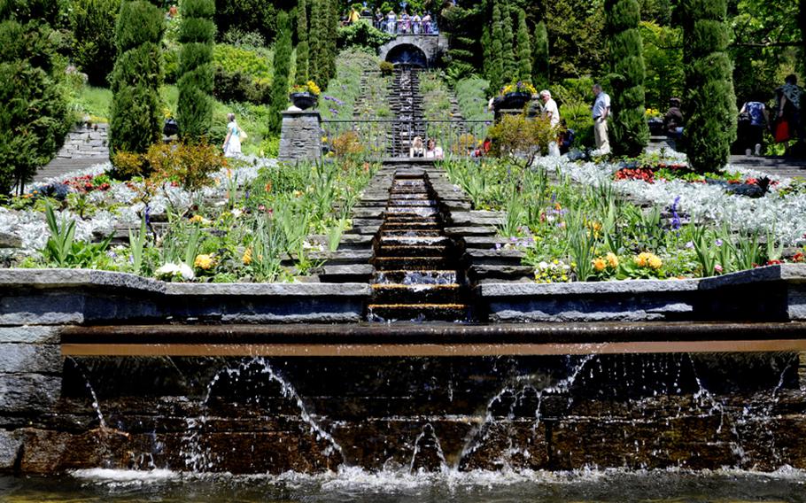 A waterfall parts the stairs leading to the butterfly house on the island of Mainau in Lake Constance, Germany.