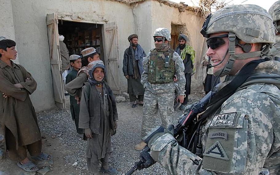 U.S. Army 1st Lt. Jared Tomberlin, from Bravo Company, 1st Battalion, 4th Infantry Regiment, studies the crowd&#39;s activity, during a meeting with village elders, near Forward Operating Base Lane, in Zabul province, Afghanistan, Feb. 17, 2009. The 1-4 Infantry&#39;s mission in Afghanistan is ending this year.