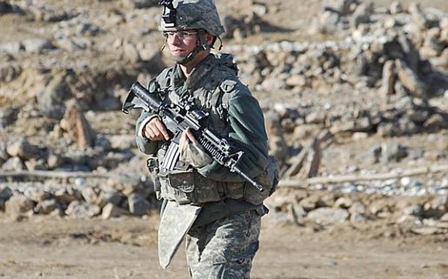 Spc. John Bentley, 22, of 1st Platoon, Company A, 1st Battalion, 4th Infantry Regiment, patrols through a graveyard in Mizan District, Afghanistan, in December 2007. The 1-4 Infantry&#39;s mission in Afghanistan is ending this year.