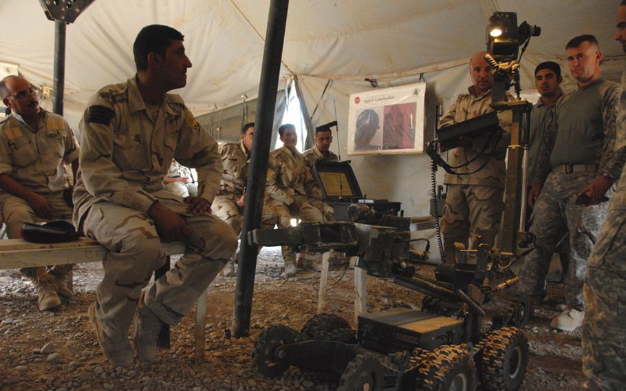 An Iraqi soldier shows off his skills with a robot used to examine possible explosives from a remote location. ?You can tell they have learned a lot more since I was here last time,? said Staff Sgt. Matthew Hutzenbiler, 29, of Belfield, N.D., who spent his first tour in Iraq in Taji during the 2007-2008 surge.