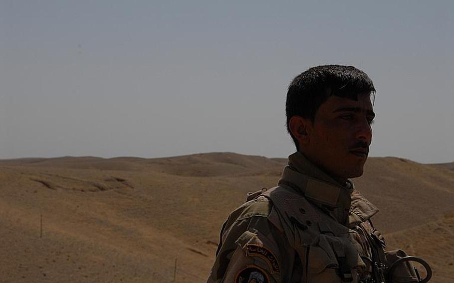 An Iraqi soldier stands watch at the hilltop outpost, one of the few spots in the area that draws mortar attacks. About six weeks ago, two shells hit within 100 meters of the hilltop within 10 minutes of each other. No one was injured.