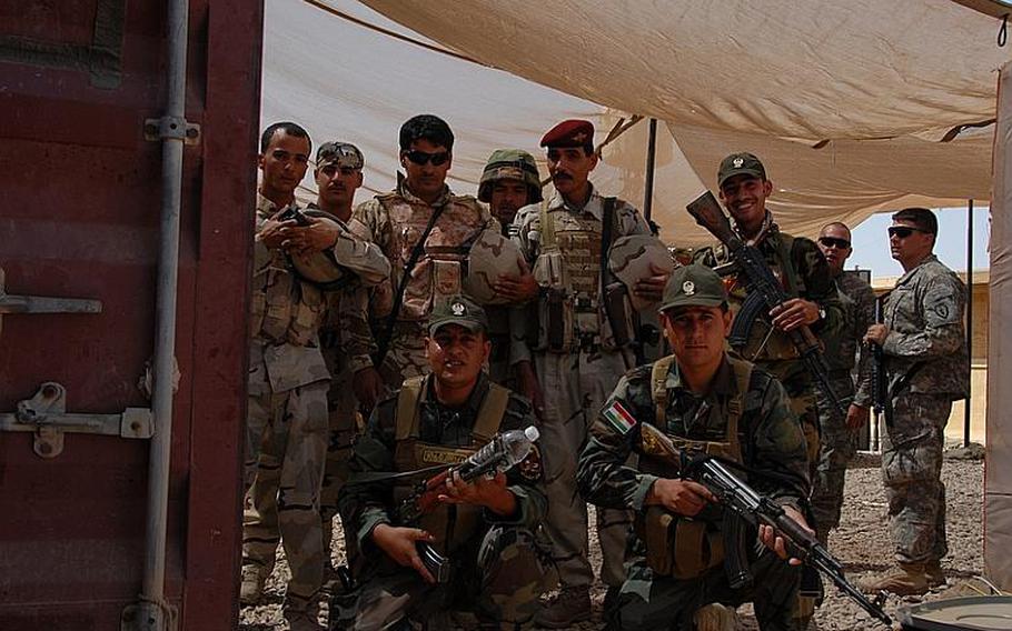 A group of Iraqi and Peshmerga soldiers pose before a shift at Checkpoint 3. "We are all Iraqis and we appreciate the U.S. forces," the Iraqi brigadier general said during the radio show, to another questioner who wanted to know who would protect the Peshmerga soldiers once the U.S. leaves. "They are going home, and we will continue to cooperate."