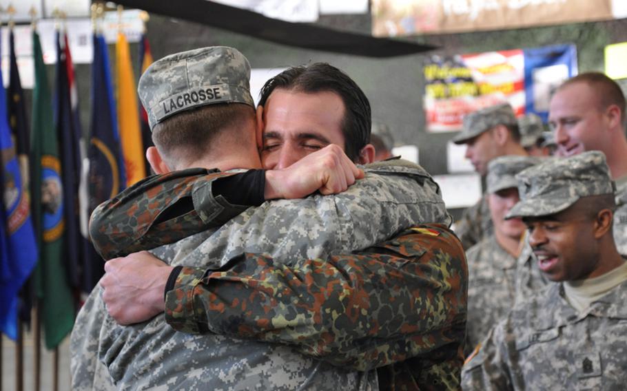 Chief Warrant Officer 3 Jason LaCrosse embraces Master Sgt. Patrick Bonneik, a German Joint Terminal Attack Controller, following an award ceremony Monday in Katterbach, Germany. LaCrosse, who was awarded the Silver Star at the ceremony, was one of the Medevac pilots who landed under heavy fire to rescue several injured German soldiers during an ambush near Kunduz in northern Afghanistan on April 2.