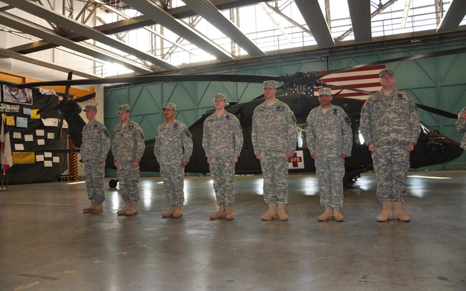 From right to left: Sgt. Steven Shumaker, Sgt. Antonio Gattis, Staff Sgt. Travis Brown, Chief Warrant Officer 2 Jason Brown, Chief Warrant Officer 3 Nelson Visaya, Capt. Robert McDonough and Chief Warrant Officer 3 Jason LaCrosse stand during an award ceremony Monday in Katterbach, Germany. LaCrosse was awarded a Silver Star and the other soldiers were awarded Distinguished Flying Crosses for their heroic actions rescuing German soldiers who were wounded in a Taliban ambush April 2 near Kunduz in northern Afghanistan.