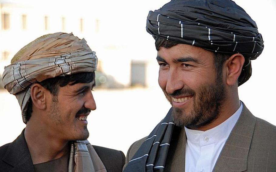 Dand&#39;s District Governor, right, Ahmidullah Nazek, pictured with his wealthy, private contractor brother, is considered one of the strongest local leaders in Kandahar province and a main reason why Dand will be ready to transition to Afghan control this spring. Insurgents know this and have tried to assisinate him repeatedly - as recently as December when he was returning to the district from Kandahar City, where he lives in a compound with 50 people including his three wives and dozen children.