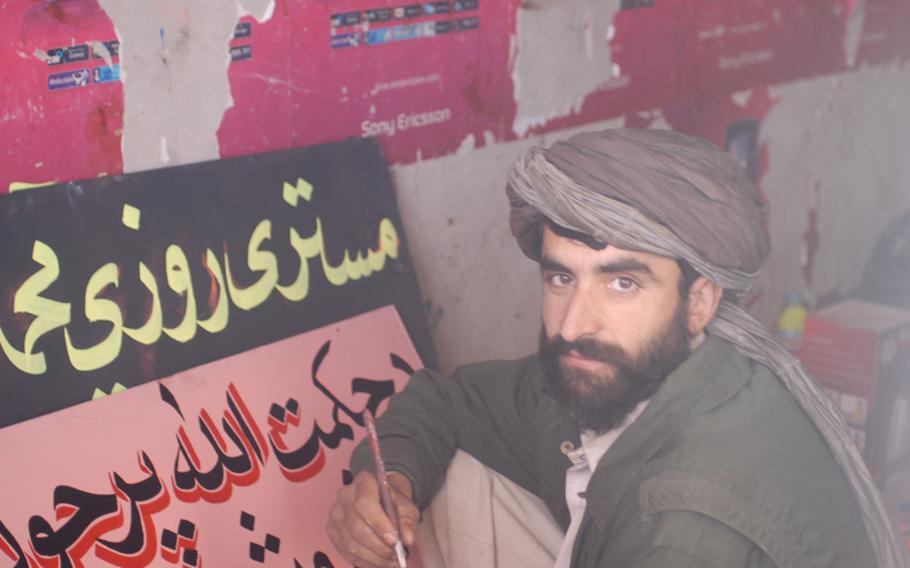 Marines are paying for Marjah shopkeepers in the bazaar to upgrade their shops, which has made Rafillh, a sign painter, a happy man. He said he's earning more than he ever has.