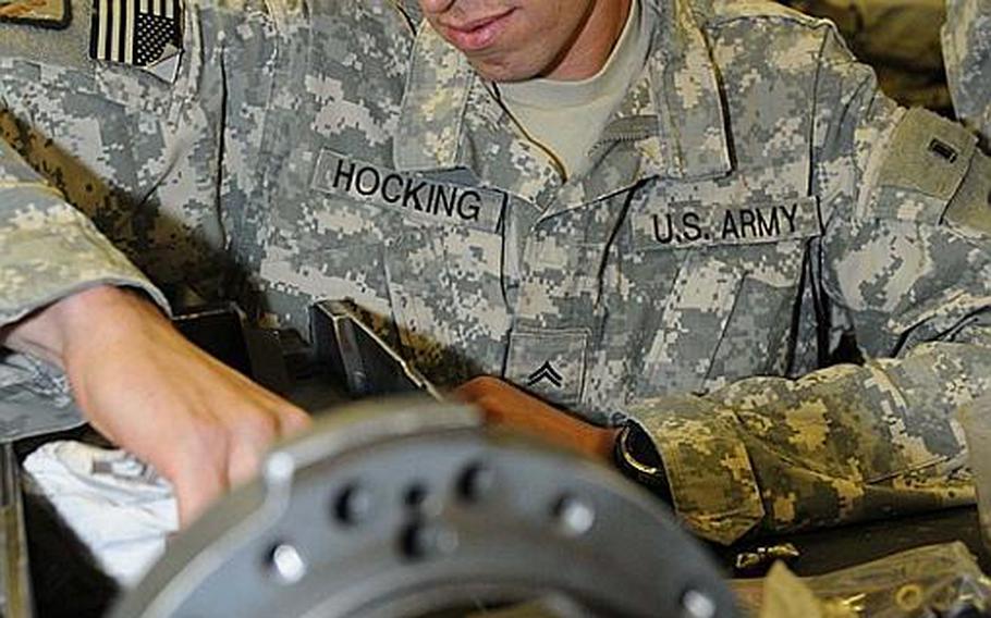 Cpl. Brandon Hocking, a small arms and artillery repair specialist with the 632nd Maintenance Company, 110th Combat Sustainment Support Battalion, 224th Sustainment Brigade, 103rd Sustainment Command (Expeditionary) and a Seattle native, cleans the bolt of a chain-fed 25 mm M242 Bushmaster autocannon in the weapons repair shop June 24 at Contingency Operating Base Adder, Iraq.