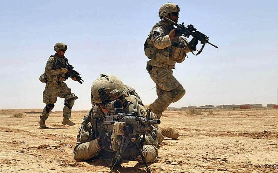U.S. Army Pfc. Robert Parker (2nd from left) provides fire support for his squad members during a live-fire exercise at the Kirkush Military Training Base in the Diyala province of Iraq on June 27, 2010.  During the exercise, U.S. and Iraqi forces trained to clear mined wired obstacles, bunker complexes and on reacting to contact.  Parker is assigned to Alpha Company, 5th Battalion, 20th Infantry Regiment, 2nd Infantry Division.