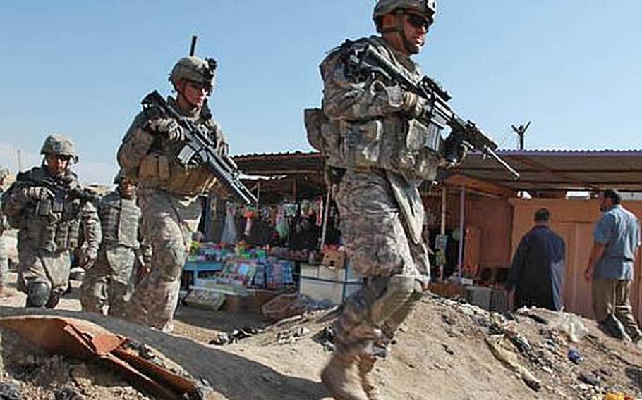 U.S. Army soldiers of 1st Battalion, 38th Infantry Regiment, 4th Stryker Brigade Combat Team, 2nd Infantry Division walk through a market in Ebnkathwer, Iraq, on Mar. 3, 2010.  The mission was part of a pre-election battlefield circulation to give a survey on how the sector is functioning prior to the elections.