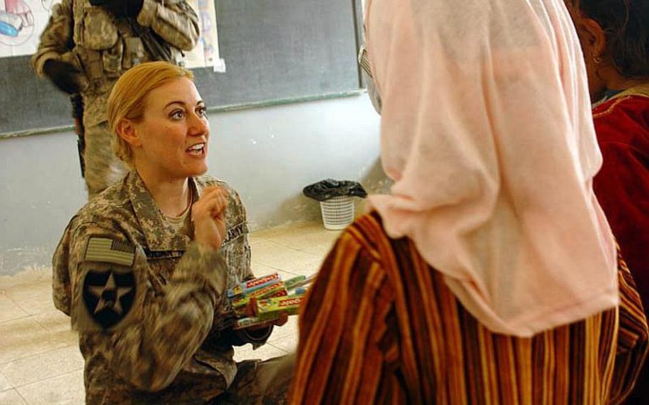 U.S. Army Capt. Marry Noland (left), a preventive medical officer, talks to local Iraqi children on the importance of washing their hands and brushing their teeth at the first Tripartite Medical Civil Action Project in Albu Gade, Iraq, on Feb. 9, 2010.  U.S. soldiers worked alongside Iraqi and Peshmerga army soldiers to provide local Iraqi residences with medical attention.