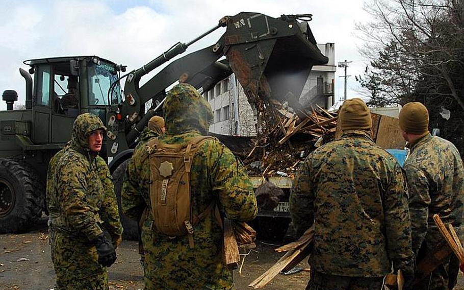 Marines with the 31st Marine Expeditionary Unit use a bulldozer to clean up debris on Oshima Island, Japan, on April 4.
