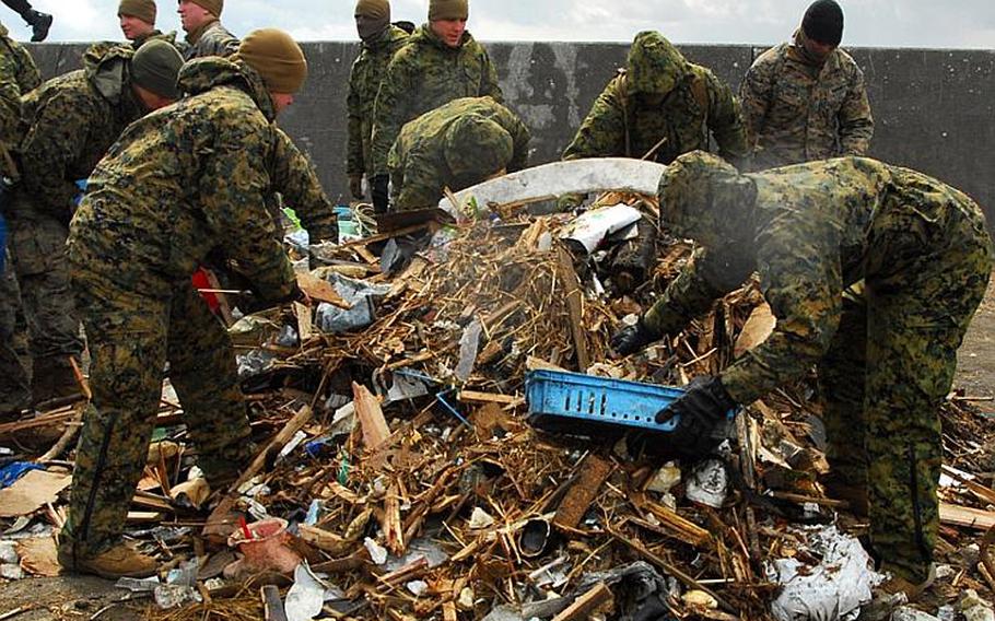 Marines with the 31st Marine Expeditionary Unit clean up debris on Oshima Island, Japan, on April 4 as part of disaster relief efforts.