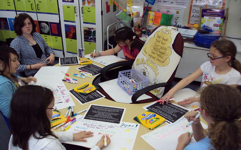 M.C. Perry students at Marine Corps Air Station Iwakuni, Japan, creat posters to announce their fundraising efforts.