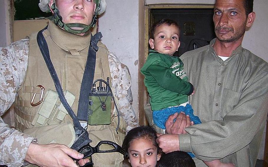Former Marine Capt. Rye Barcott, left, with an Iraqi family in Fallujah in February 2006.  Barcott helped run Carolina for Kibera, a nongovernmental organization designed to improve the lives of people in a Nairobi slum, while he served in the Marines.