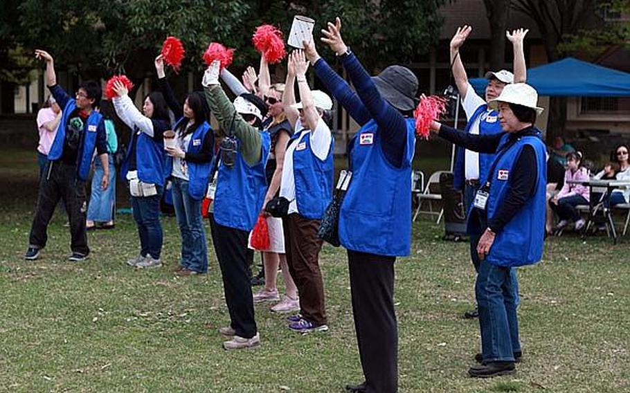 Volunteers from the American Red Cross cheer for donations at &#39;Tomodachi Stock&#39;  Saturday at the Sakura Shell on Yokota Air Base, site of a free concert to raise money for the tsunami victims in northern Japan.