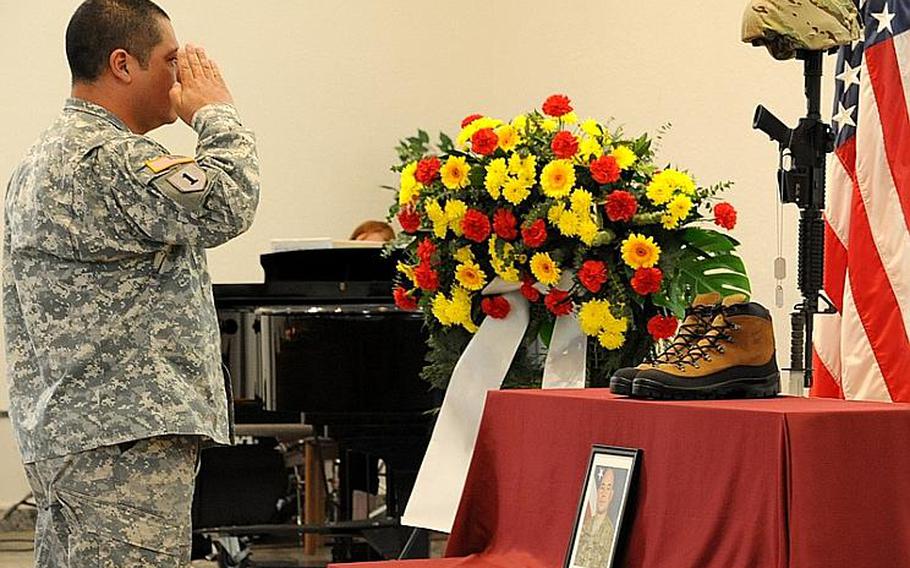 A soldier gives a final salute Wednesday to Staff Sgt. Jose M. Caraballo Pietri at a memorial ceremony for the 1st Battalion, 84th Field Artillery soldier in Baumholder, Germany.